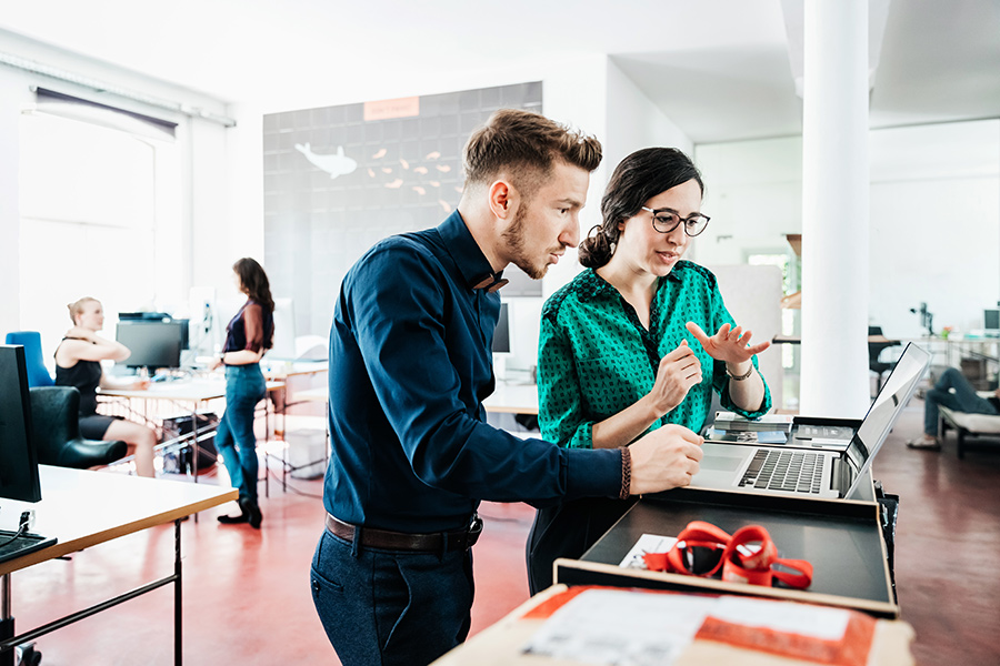 Man and women having conversation at work